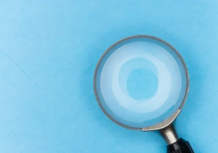 Magnifying glass on a blue background