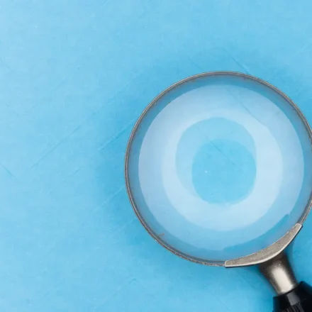Magnifying glass on a blue background