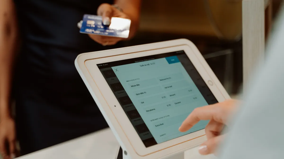 customer using a tablet checkout screen with card payment