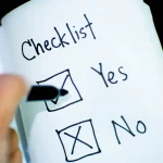 hand checking items off a paper checklist