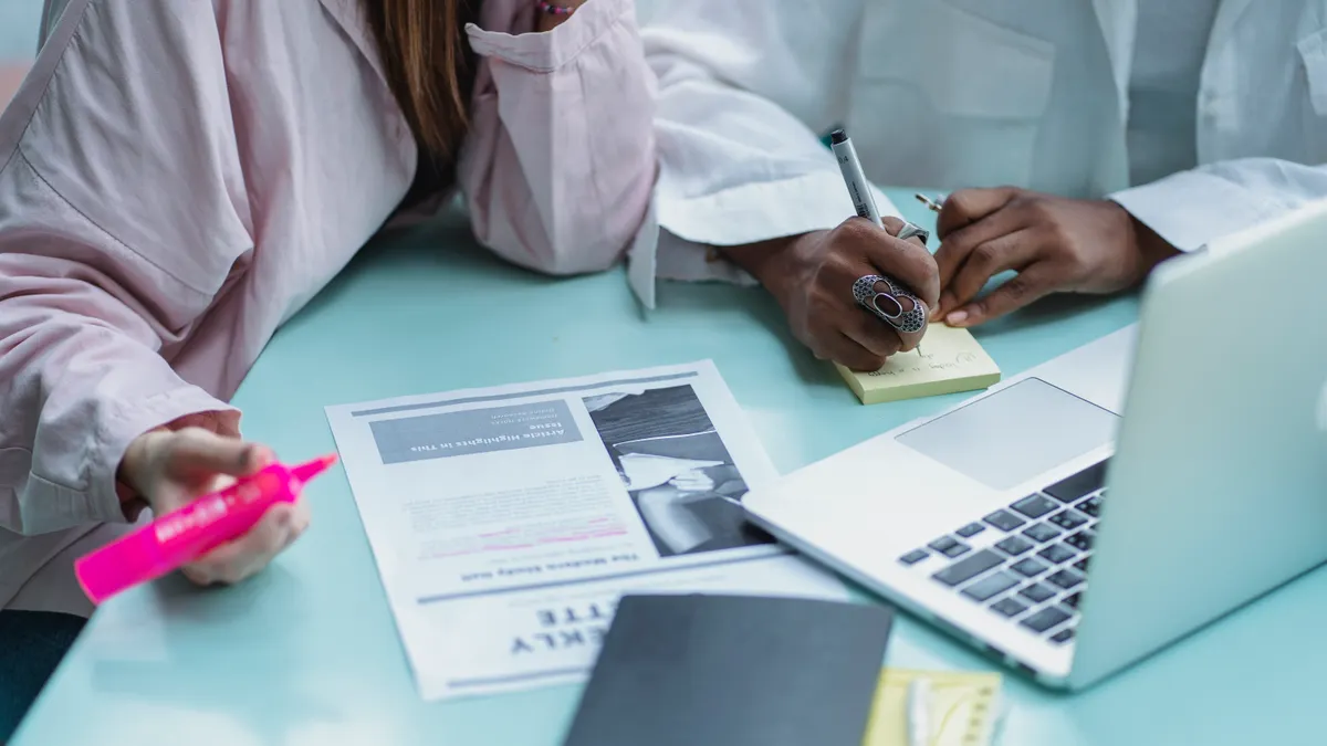 SEO article writing fundamentals — The Complete Guide SEO article writing fundamentals — The Complete Guide — Crop multiracial students writing on sticky notepad near laptop